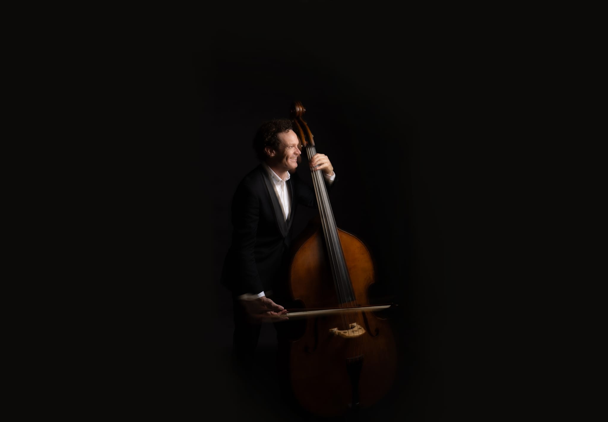 A QSO double bassist, from the orchestra's 80th anniversary season campaign photography.